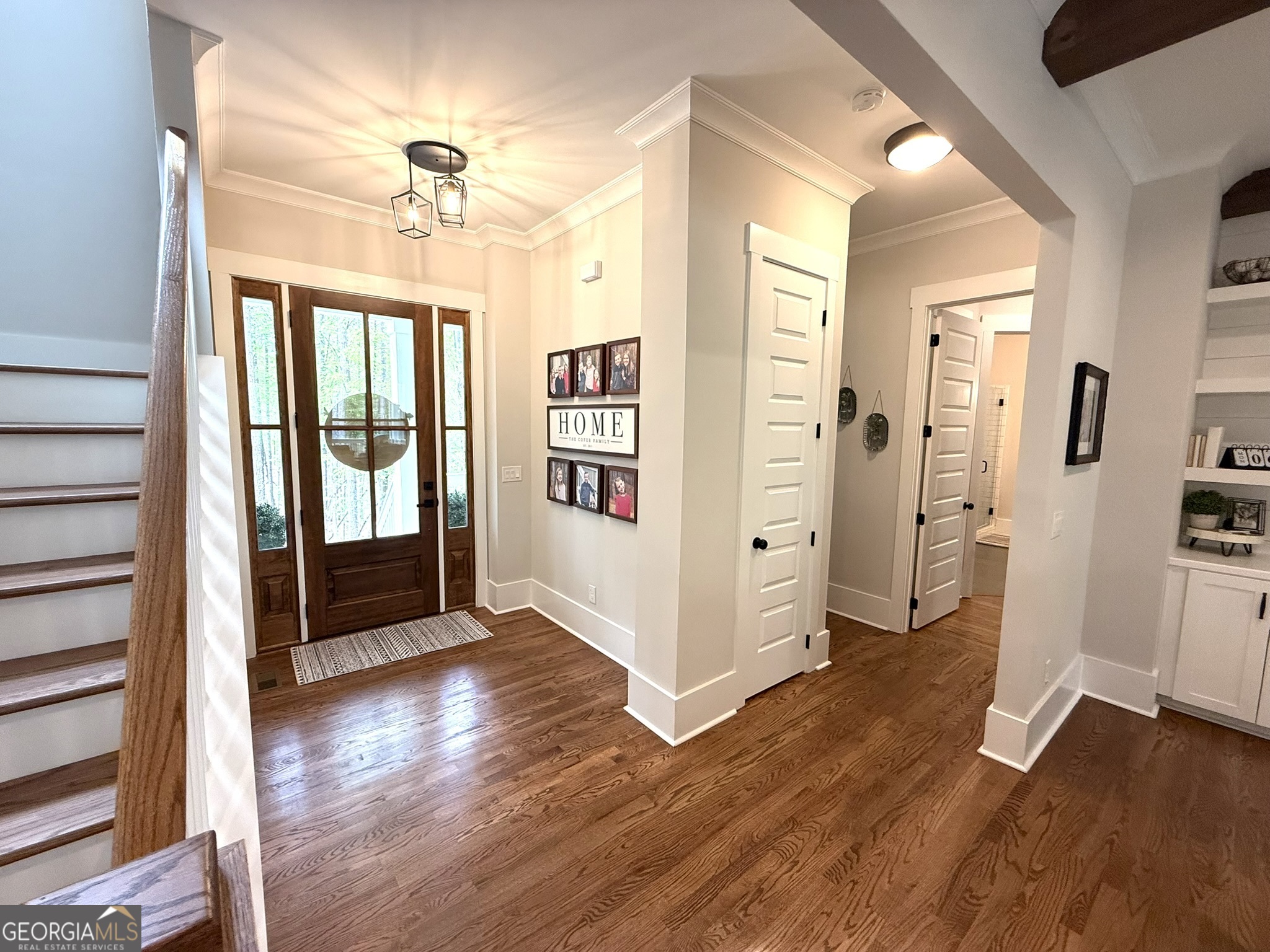 120 Spring Creek Drive Rutledge, GA 30663 - Photo 4 of 38 a view of a hallway with wooden floor and a living room