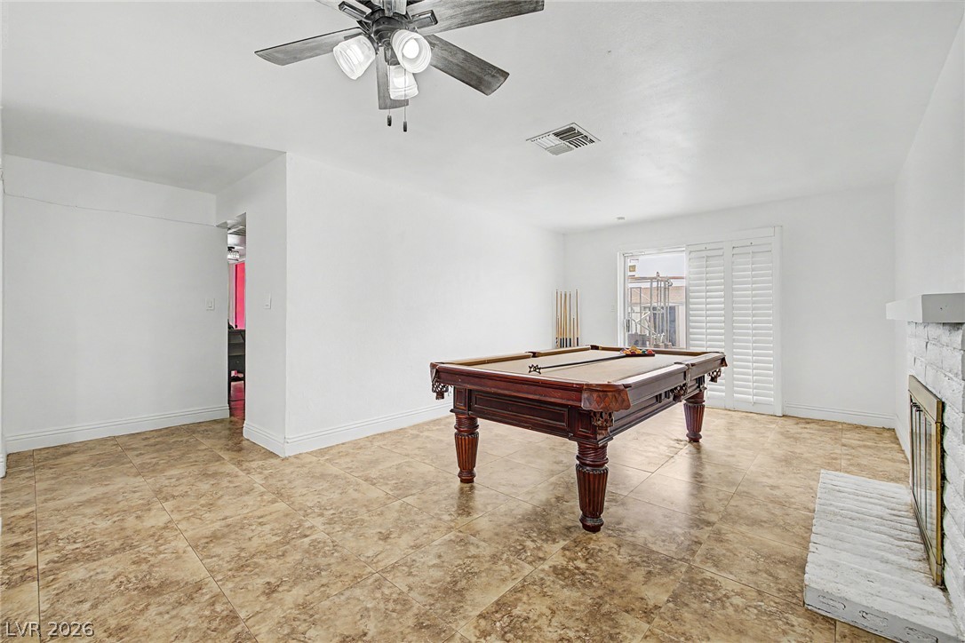 5357 Indian Wells Road Las Vegas, NV 89110 - Photo 16 of 39 A spacious recreation area features ceramic tile flooring and a cozy fireplace.