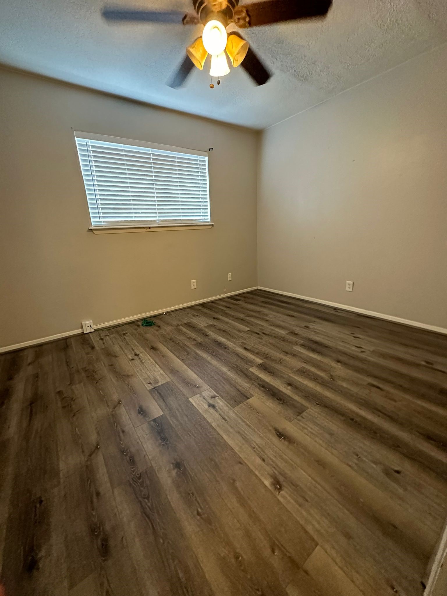 7305 South Gessner Road Houston, TX 77036 - Photo 18 of 24 a view of an empty room with window and chandelier fan