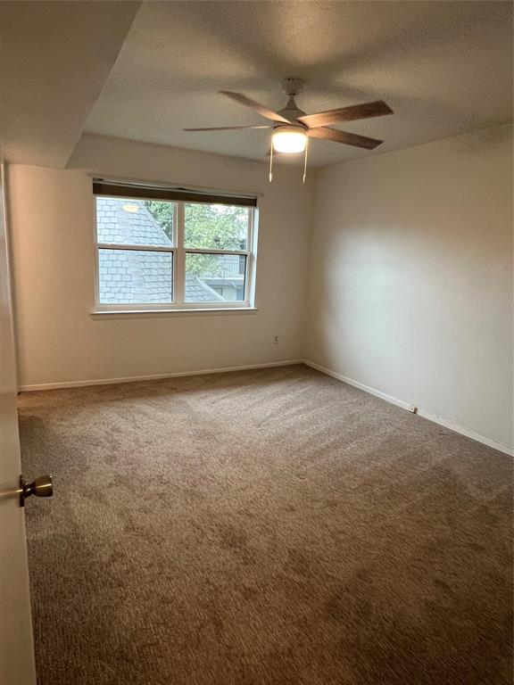 3929 Inwood Road, Unit 2021 Dallas, TX 75209 - Photo 16 of 24 Wall-to-wall carpeting, white painted walls, and a multi-pane window