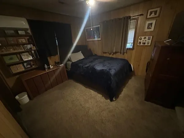 a bed sitting in a bedroom next to a window