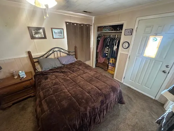 a bed sitting in a bedroom next to a window