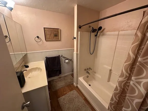 a bathroom with a bathtub and shower