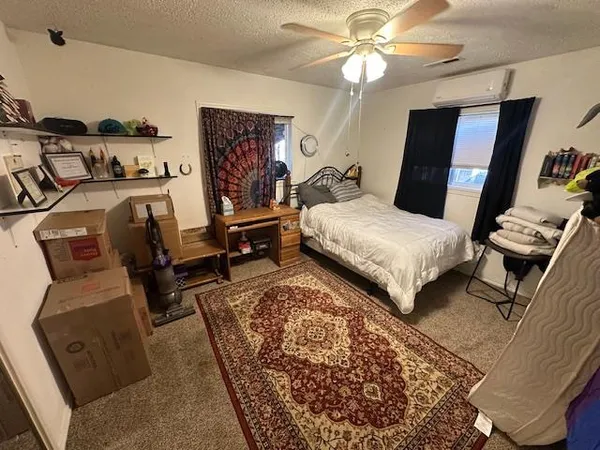 a bedroom with bed and a mirror