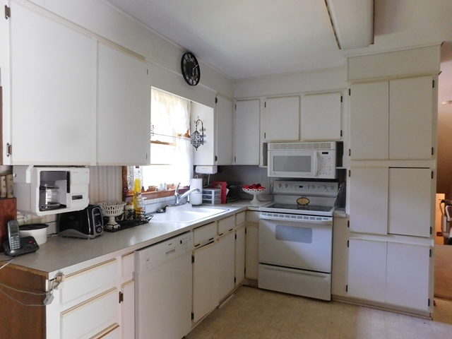 303 Pinecrest Road Warner Robins, GA 31093 - Photo 6 of 6 a kitchen with cabinets appliances a sink and a window