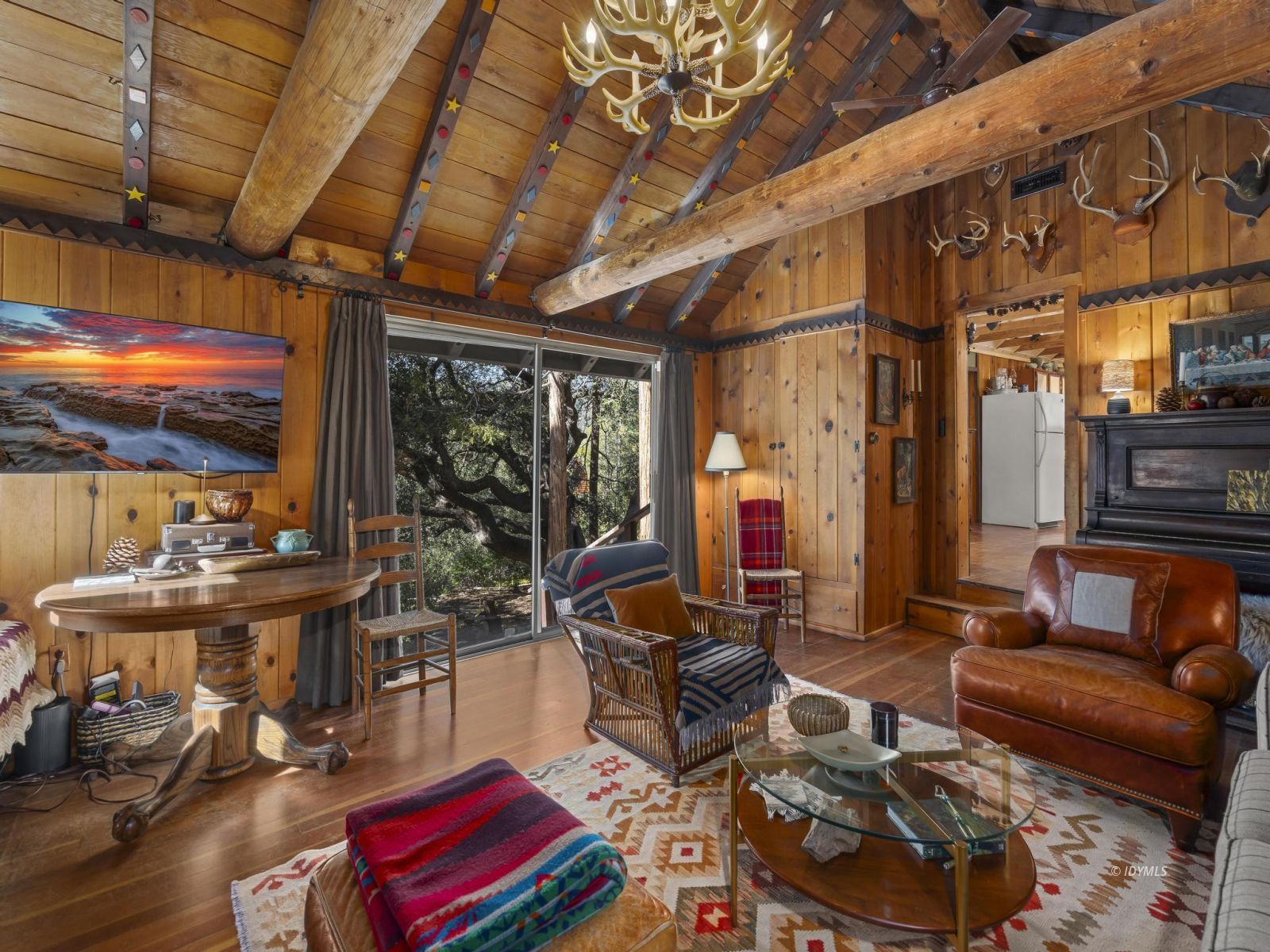 53241 Middleridge Drive Idyllwild, CA 92549 - Photo 16 of 48 a living room with furniture a rug and a chandelier