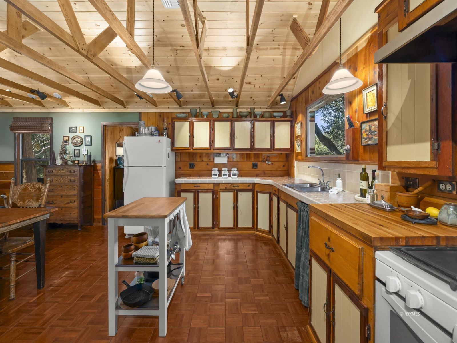 53241 Middleridge Drive Idyllwild, CA 92549 - Photo 21 of 48 a kitchen with stainless steel appliances granite countertop a sink a stove cabinets and a dining table