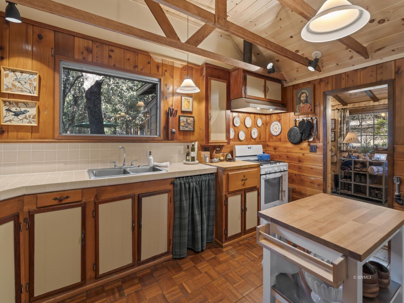 53241 Middleridge Drive Idyllwild, CA 92549 - Photo 23 of 48 a kitchen that has a sink a stove and a wooden floor