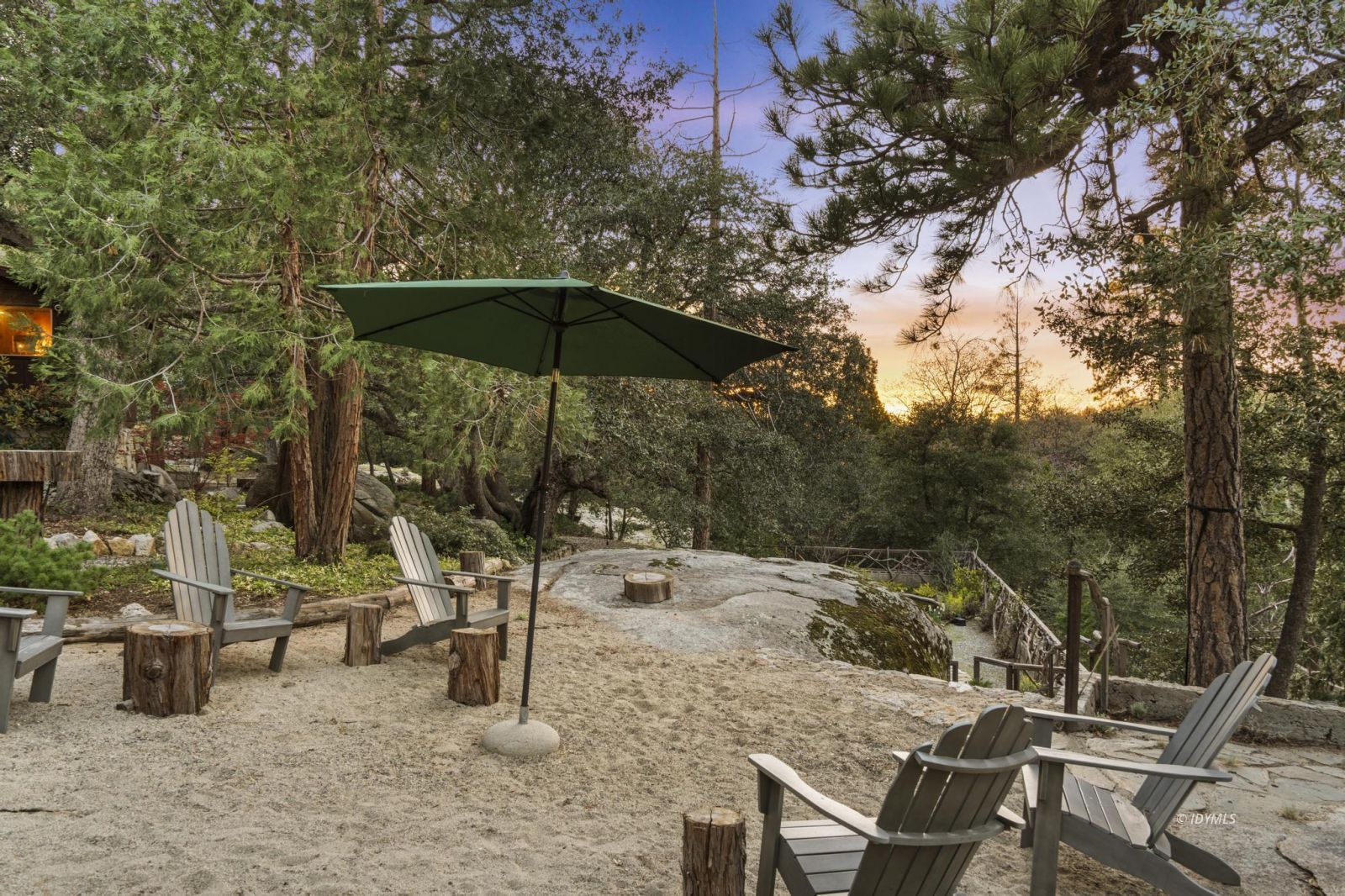 53241 Middleridge Drive Idyllwild, CA 92549 - Photo 39 of 48 a view of backyard with a table and chairs under an umbrella