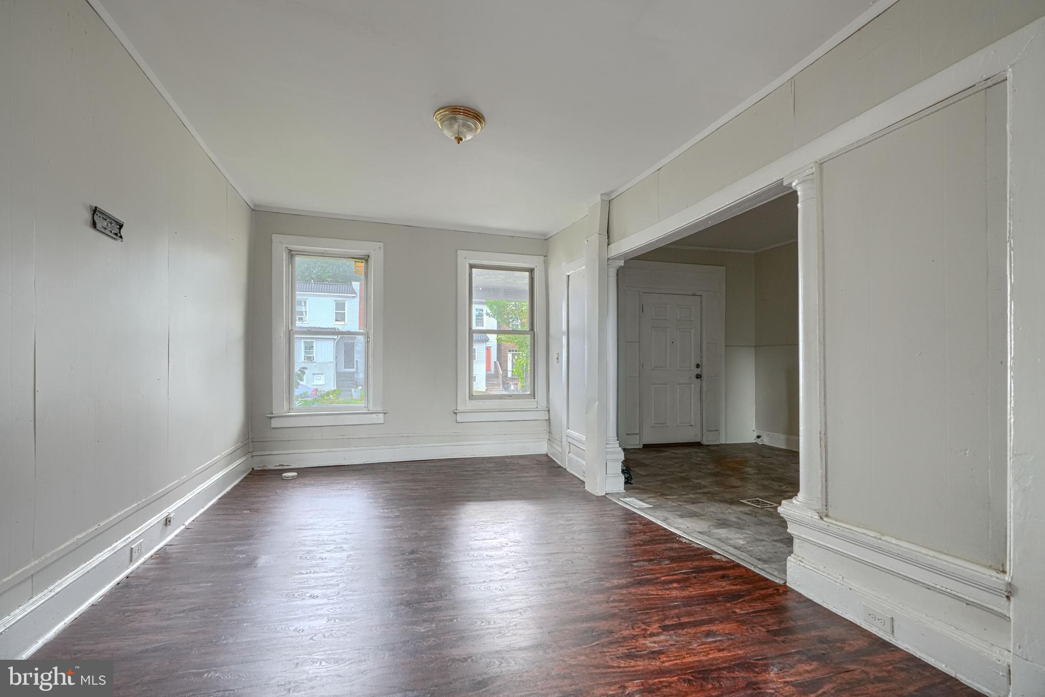 4806 Reisterstown Road Baltimore, MD 21215 - Photo 8 of 34 an empty room with wooden floor and windows