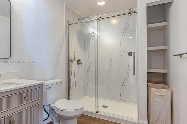 a bathroom with a shower a toilet and a sink