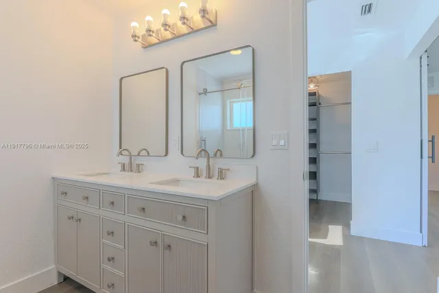 a bathroom with a double vanity sink and mirror