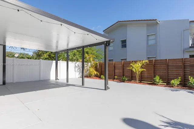 a view of an empty room with a floor to ceiling window and a flat screen tv