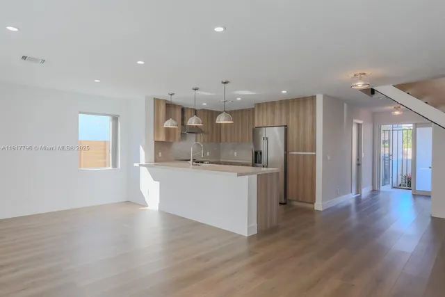 a view of a kitchen with a sink and a window