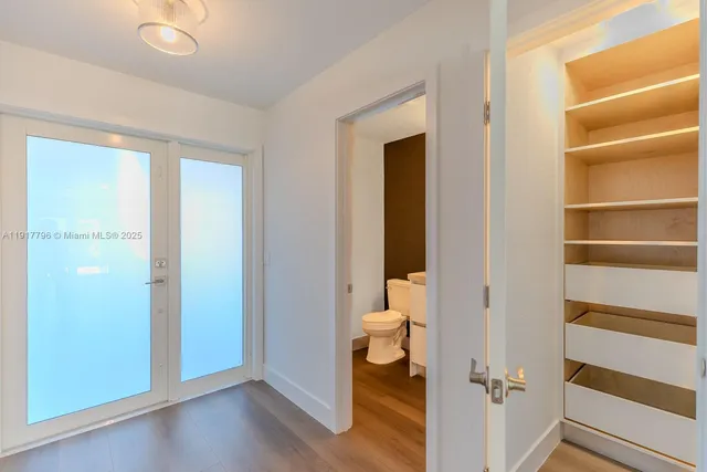 a bathroom with a toilet and a shower