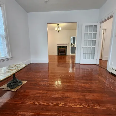 a view of livingroom with hardwood floor and front door