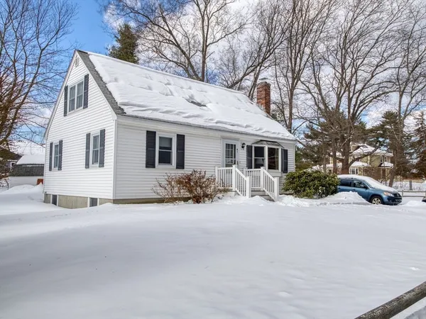 a view of a house with a yard covered in snow