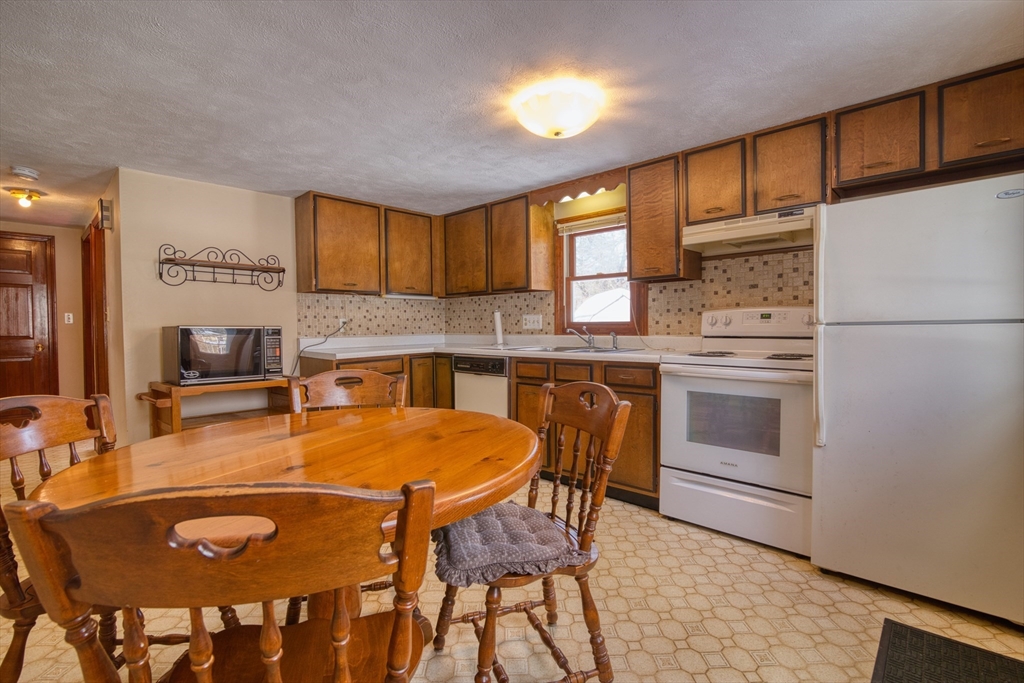 41 Taylor Road Maynard, MA 01754 - Photo 5 of 27 a kitchen with stainless steel appliances granite countertop a stove a sink a microwave and a refrigerator