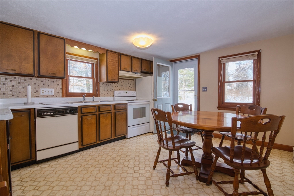 41 Taylor Road Maynard, MA 01754 - Photo 6 of 27 a kitchen with a table chairs sink and cabinets