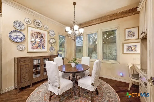 a dining room with wooden floor and a chandelier