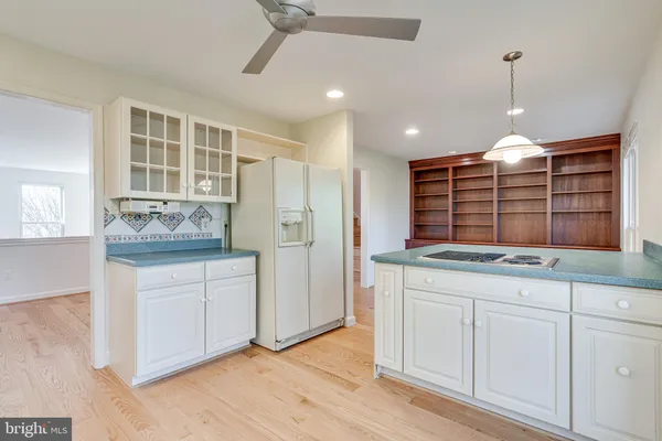a kitchen with granite countertop white cabinets and white appliances