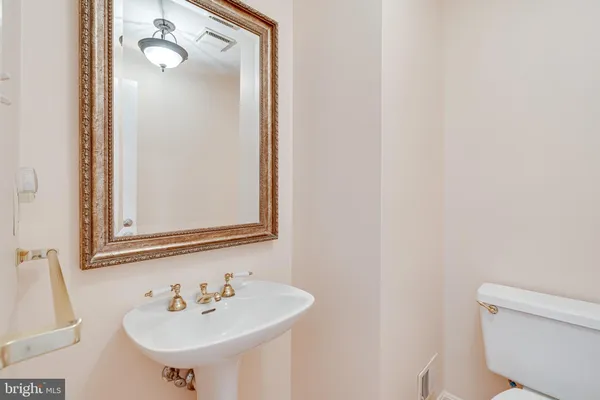 a bathroom with a sink a toilet and mirror