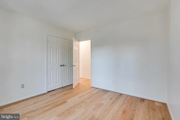 a view of an empty room and wooden floor