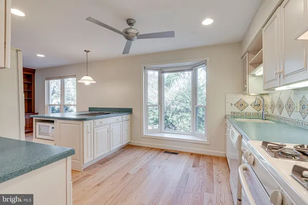 a large kitchen with stainless steel appliances granite countertop a stove a sink and a refrigerator