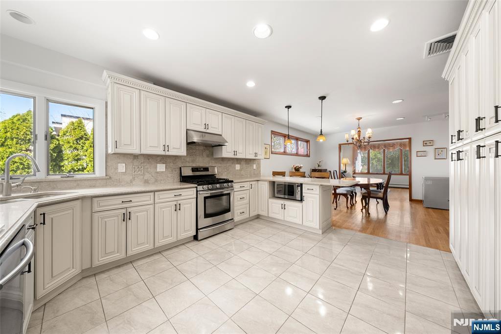 19 Central Avenue Demarest, NJ 07627 - Photo 12 of 49 a kitchen with white cabinets and appliances
