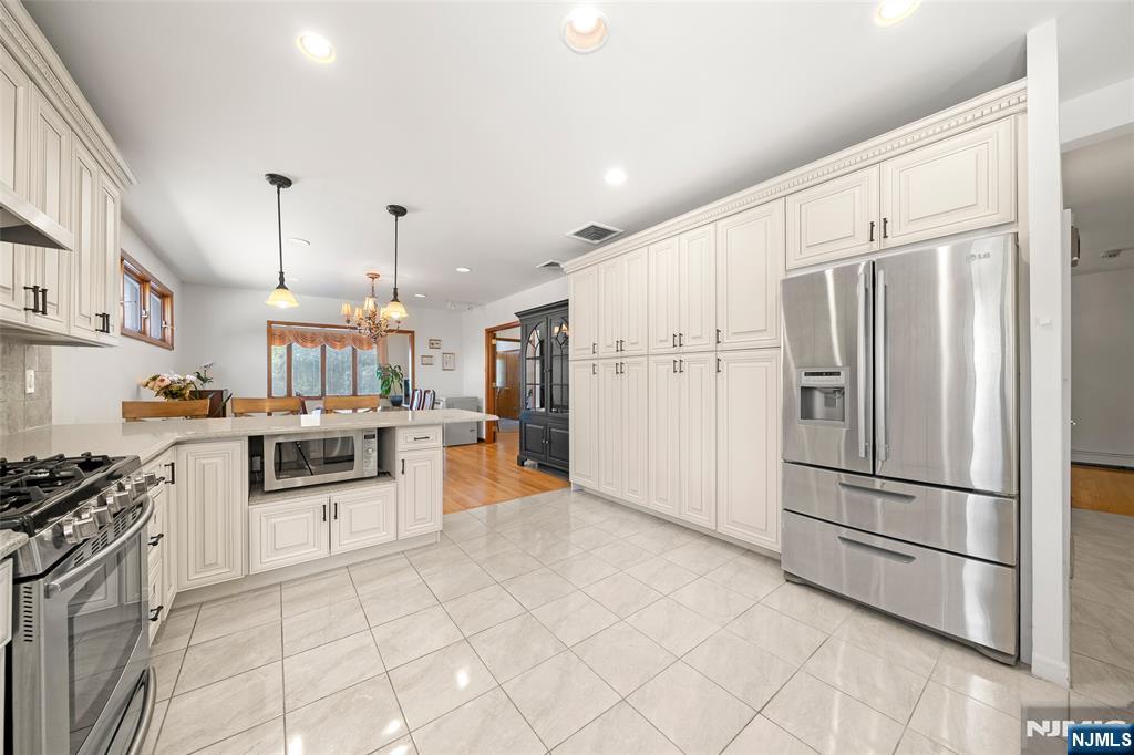 19 Central Avenue Demarest, NJ 07627 - Photo 13 of 49 a kitchen with granite countertop a refrigerator stove top oven and sink
