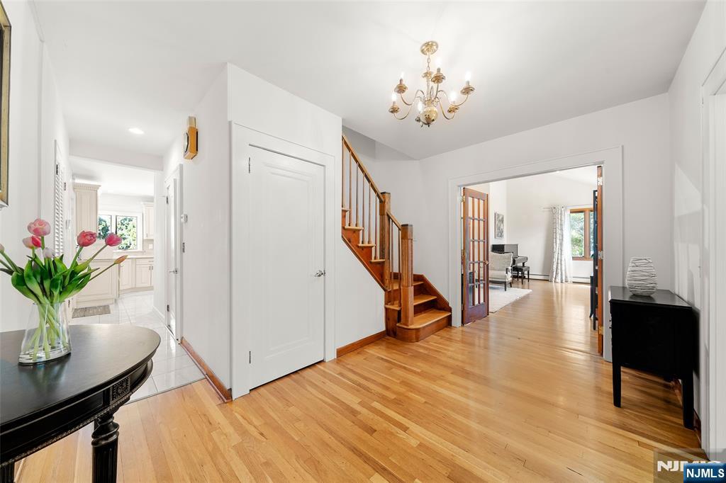 19 Central Avenue Demarest, NJ 07627 - Photo 17 of 49 a view of an entryway with wooden floor and a chandelier