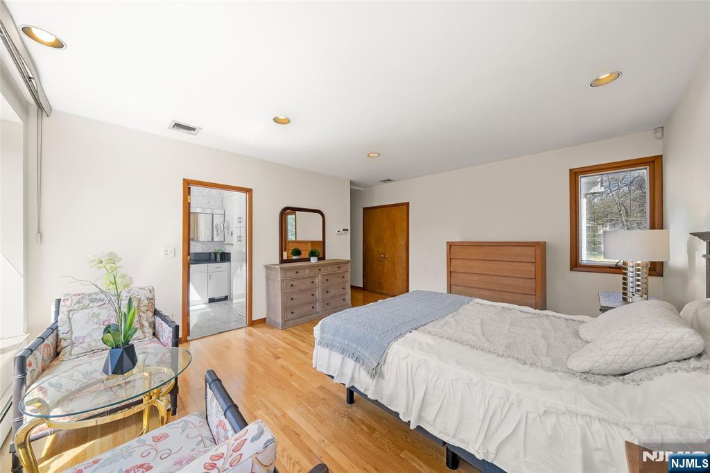 19 Central Avenue Demarest, NJ 07627 - Photo 19 of 49 a bedroom with a bed and wooden floor