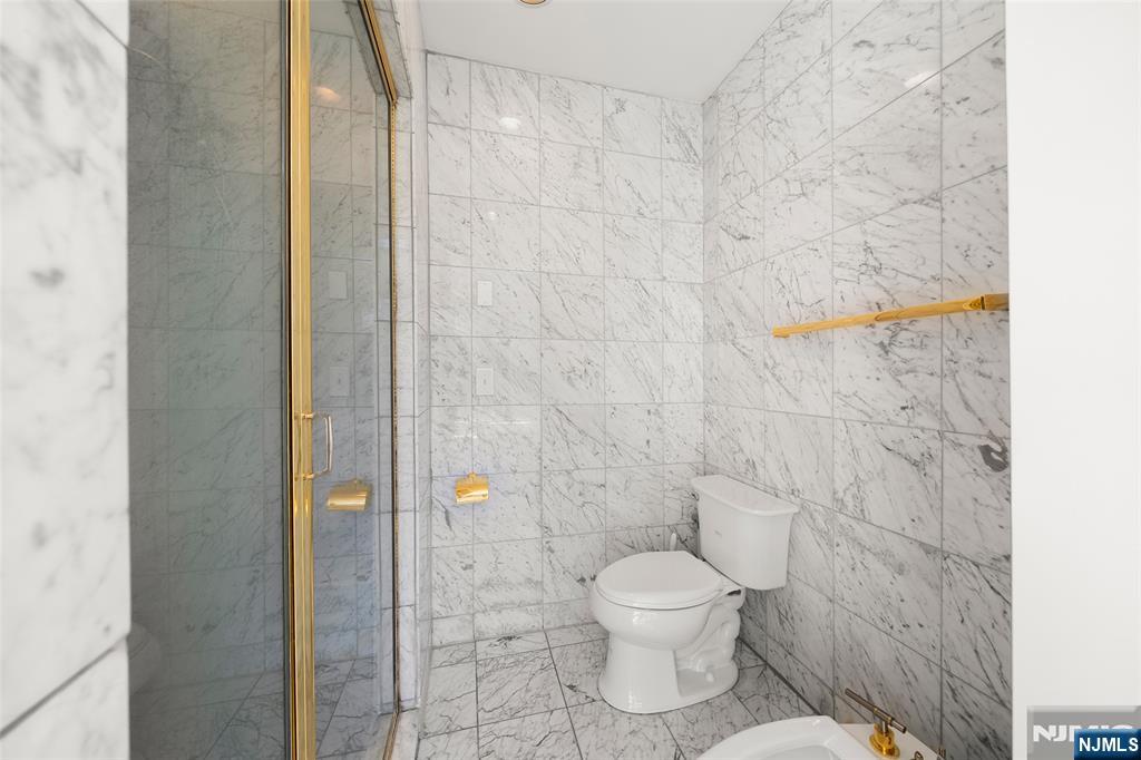 19 Central Avenue Demarest, NJ 07627 - Photo 21 of 49 a bathroom with a toilet and a shower