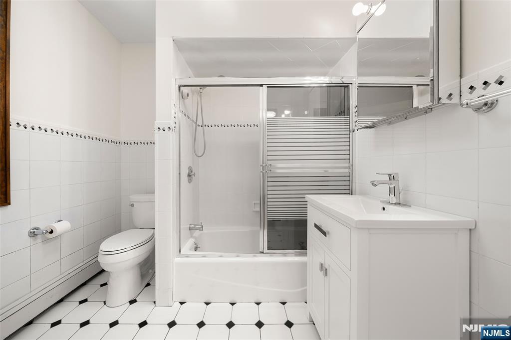 19 Central Avenue Demarest, NJ 07627 - Photo 27 of 49 a bathroom with a sink a toilet and shower