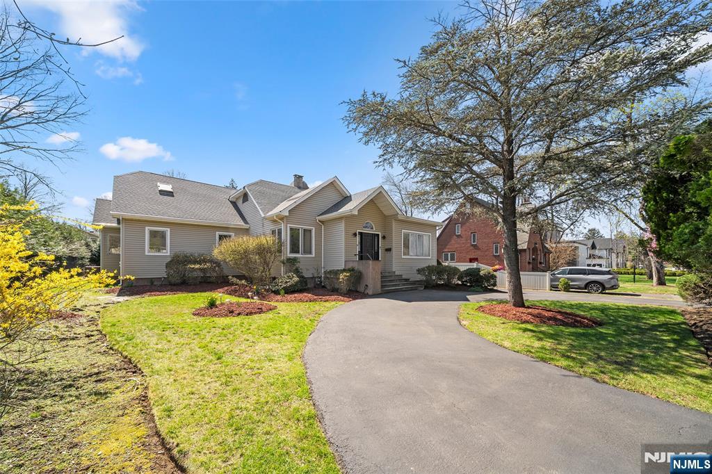 19 Central Avenue Demarest, NJ 07627 - Photo 3 of 49 a front view of a house with a yard and trees