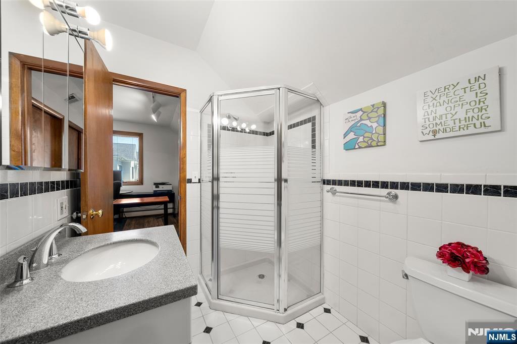 19 Central Avenue Demarest, NJ 07627 - Photo 31 of 49 a bathroom with a sink mirror and a shower