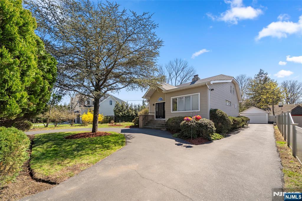19 Central Avenue Demarest, NJ 07627 - Photo 5 of 49 a front view of a house with garden and parking