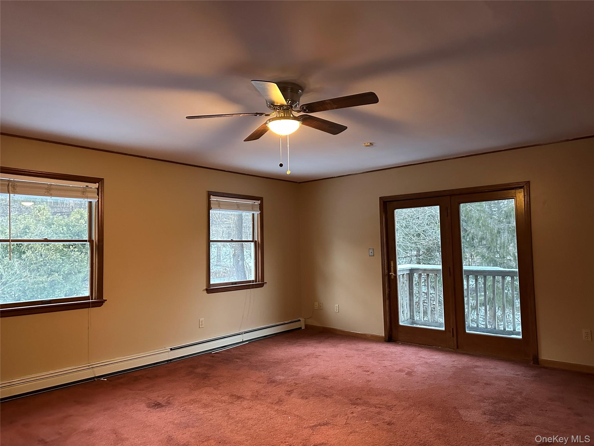 62 New Road Newburgh, NY 12550 - Photo 10 of 14 Spare room with a baseboard radiator, carpet flooring, plenty of natural light, and ceiling fan