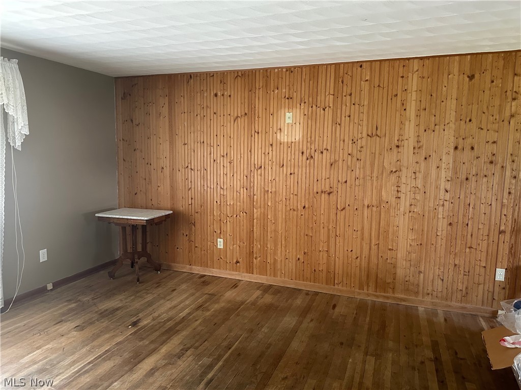 2857 McCoy Road Wooster, OH 44691 - Photo 2 of 19 Living room featuring wood walls and hardwood / wood-style floors
