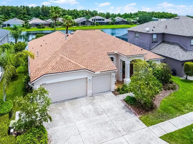 an aerial view of a house with a yard and garden
