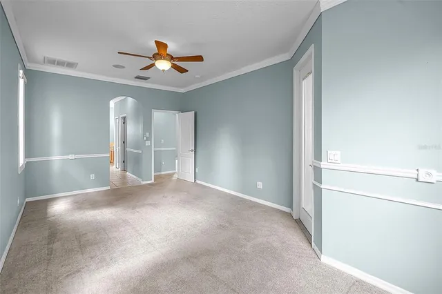 a view of an empty room with a ceiling fan