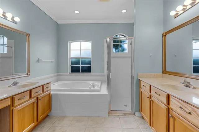 a bathroom with a tub sink and mirror