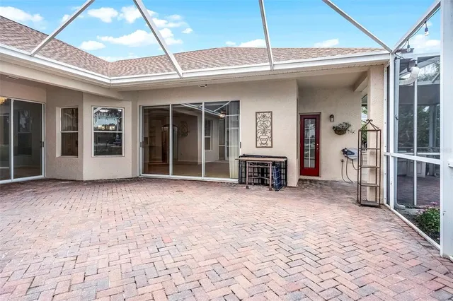 a view of a house with a porch and furniture