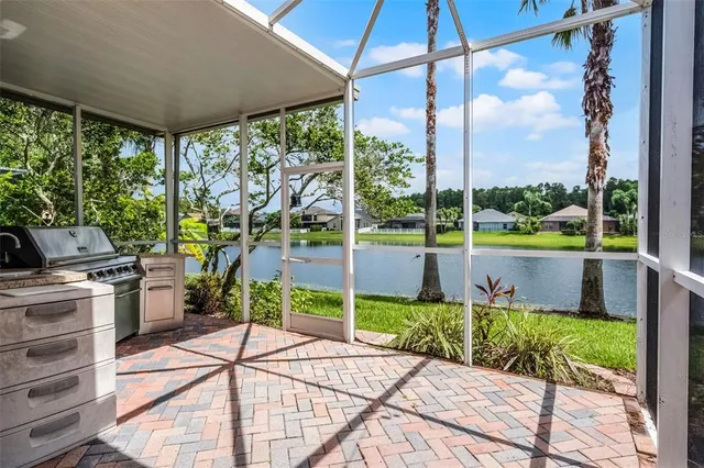 a view of a swimming pool with a porch and furniture