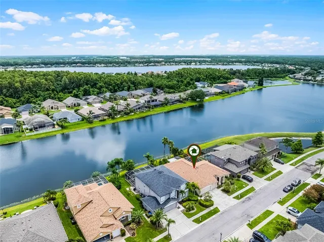 an aerial view of a house with a lake view