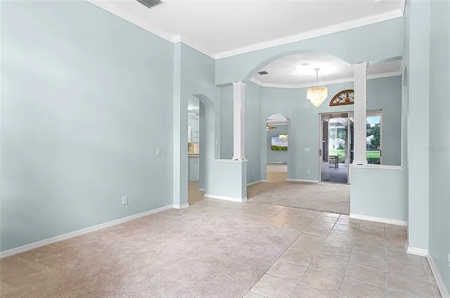 an empty room with entrance and windows