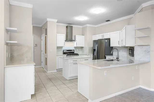 a kitchen with white cabinets and stainless steel appliances