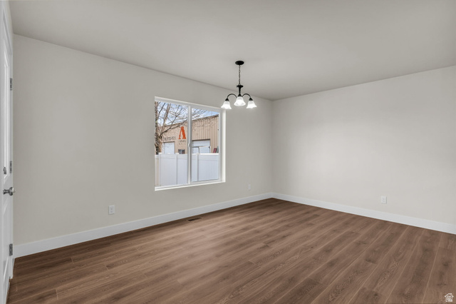 578 West 7th Midvale, UT 84047 - Photo 6 of 35 Unfurnished dining area with dark wood-style flooring and a chandelier