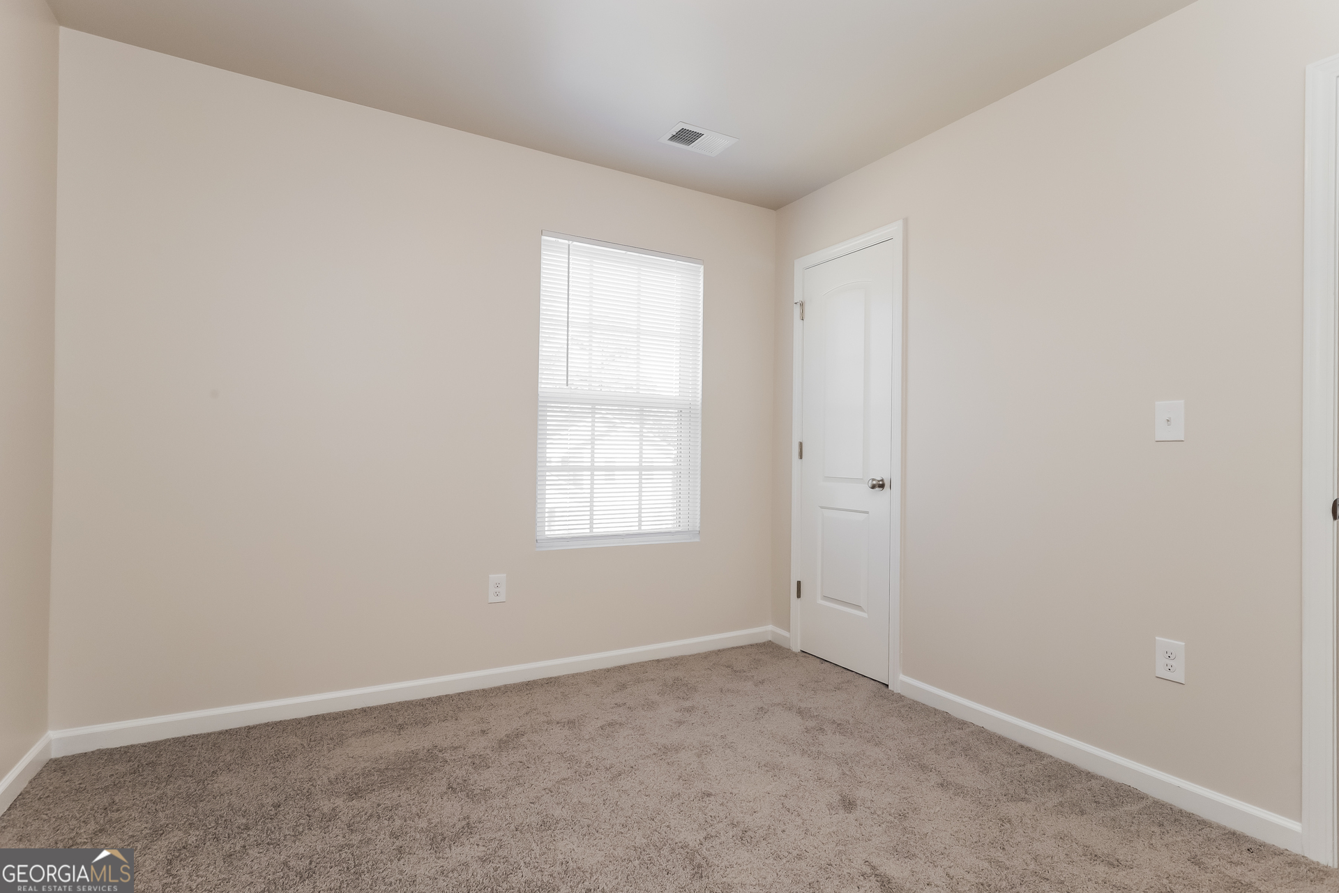 20 Sloane Court Covington, GA 30016 - Photo 11 of 16 an empty room with a window