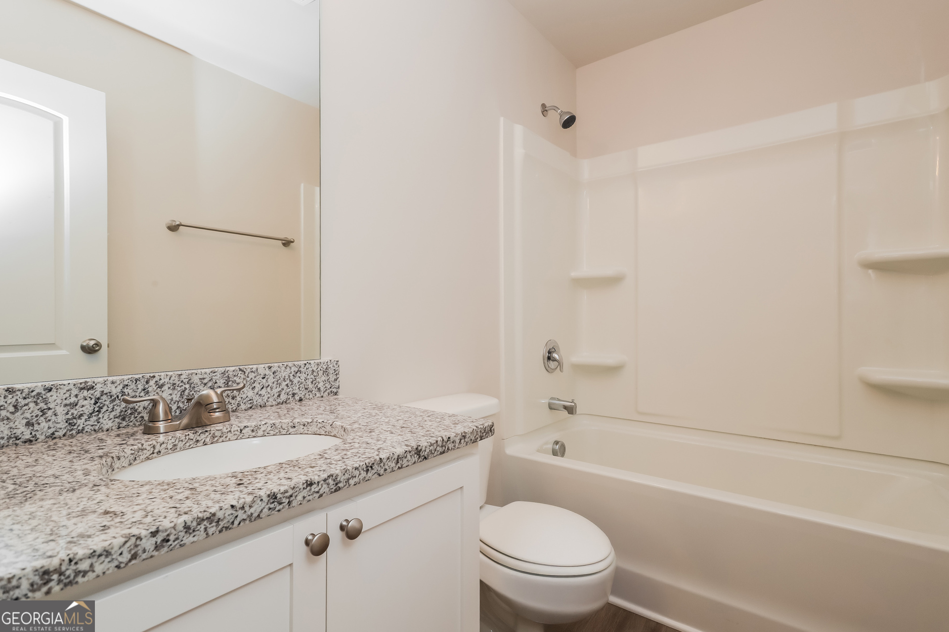 20 Sloane Court Covington, GA 30016 - Photo 13 of 16 a bathroom with a granite countertop sink a toilet and shower